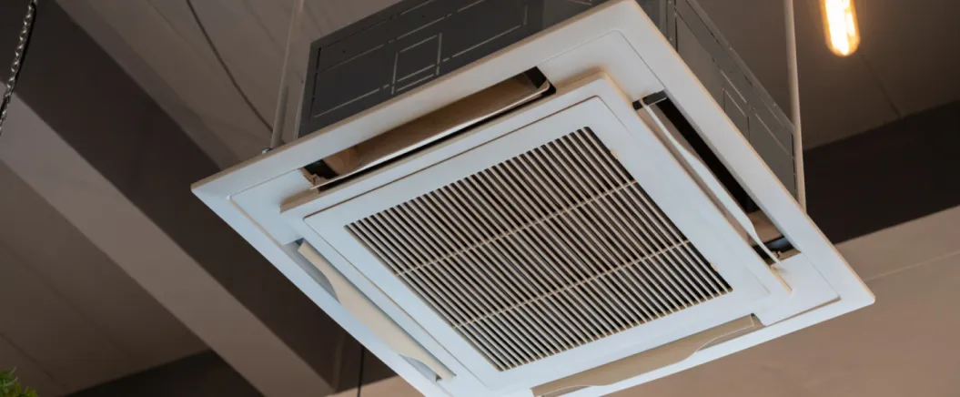 Ceiling-mounted cassette air conditioning unit in a commercial or office space.